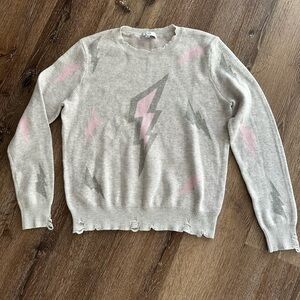 Women's distressed lightning bolt sweater, size large.